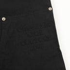 Embroidered text “DIOR COUTURE 1941” on dark pants