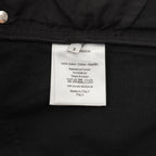 Interior label on dark pants showing 100% cotton and Made in Italy