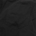 Dark pants with angled pocket panel and topstitched seams