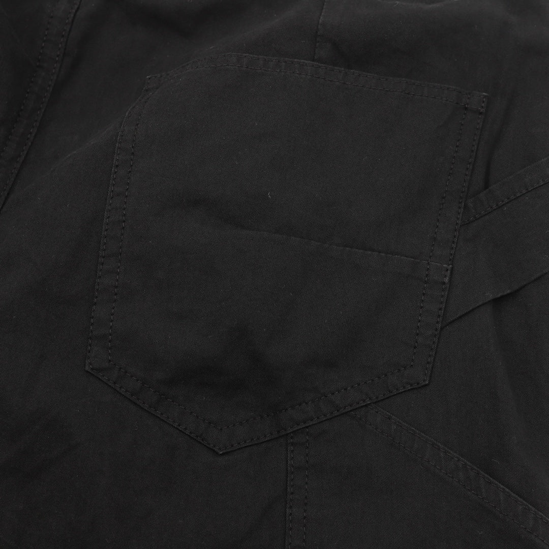 Dark pants with angled pocket panel and topstitched seams