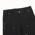 Dark pants with flap pockets and silver snap buttons