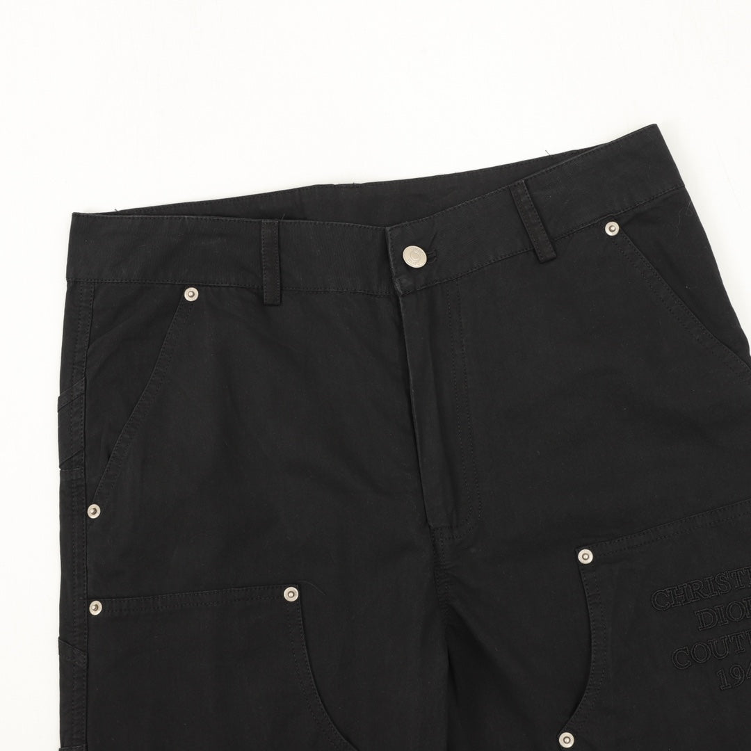 Dark pants with flap pockets and silver snap buttons
