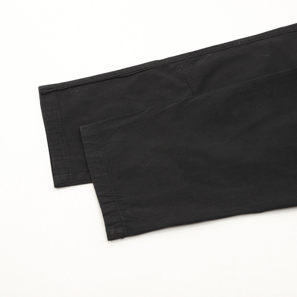 Dark pants with folded hem and inner waistband seam