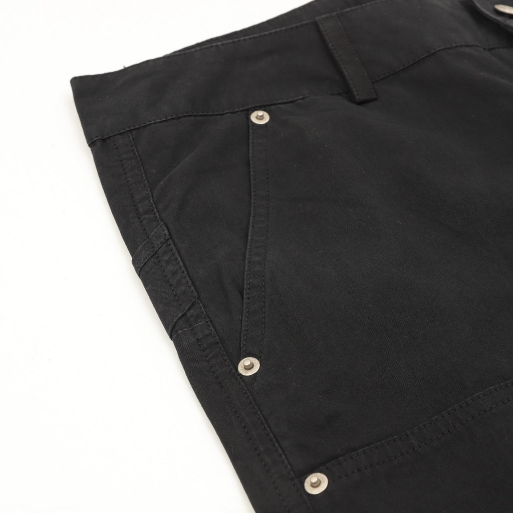Dark pants pocket with snap button closure and stitched edge