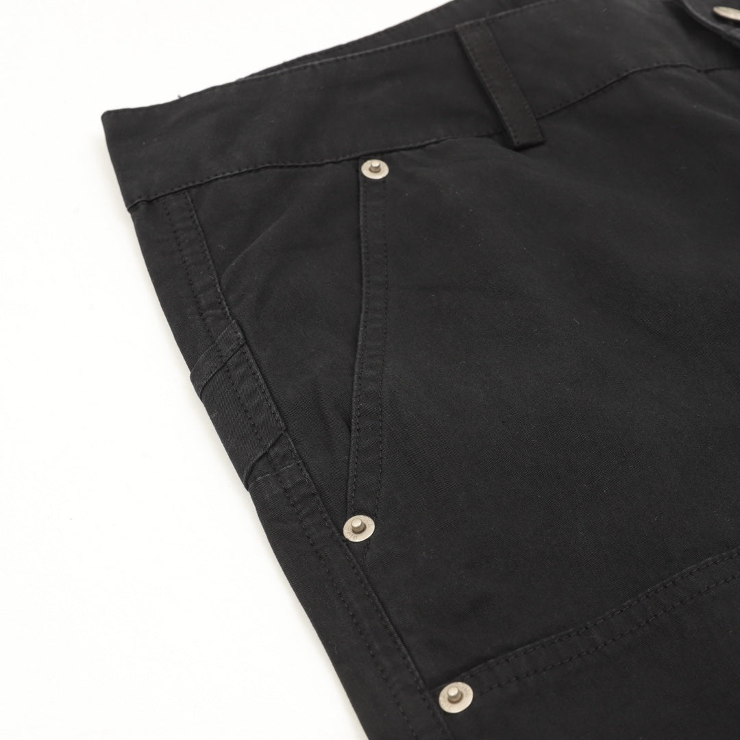 Dark pants pocket with snap button closure and stitched edge