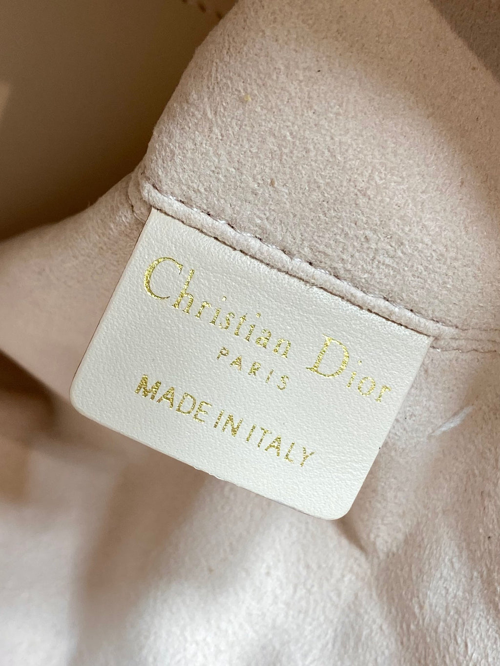 White brand label reading “Christian Dior Paris” and “Made in Italy”