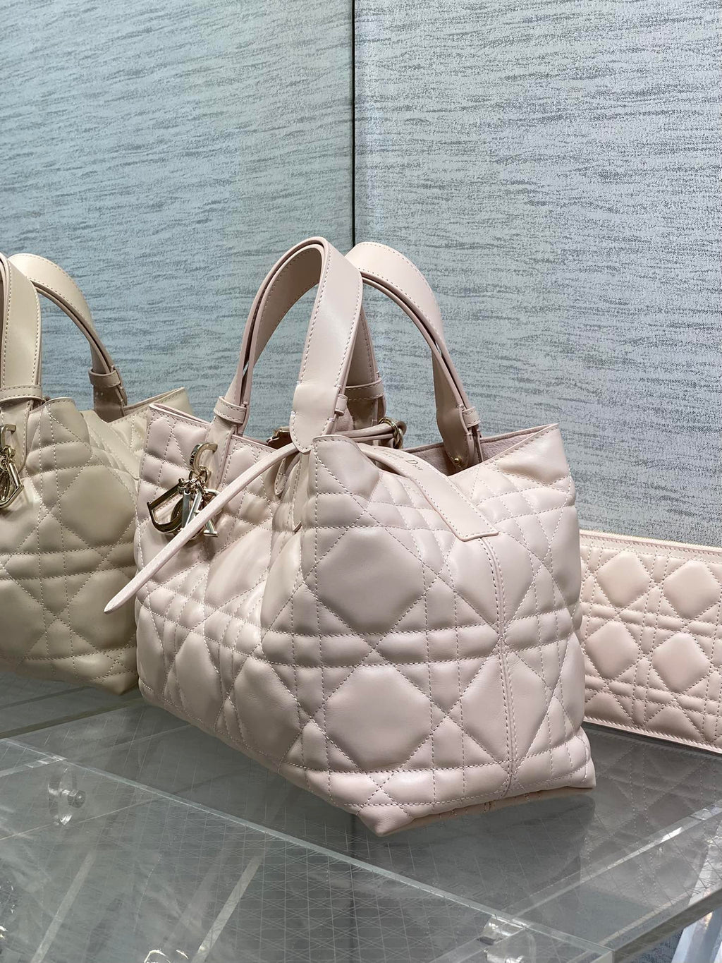 Light pink quilted small handbag with top handles and gold-tone hardware
