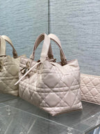 Light pink quilted small handbag with top handles and gold-tone hardware