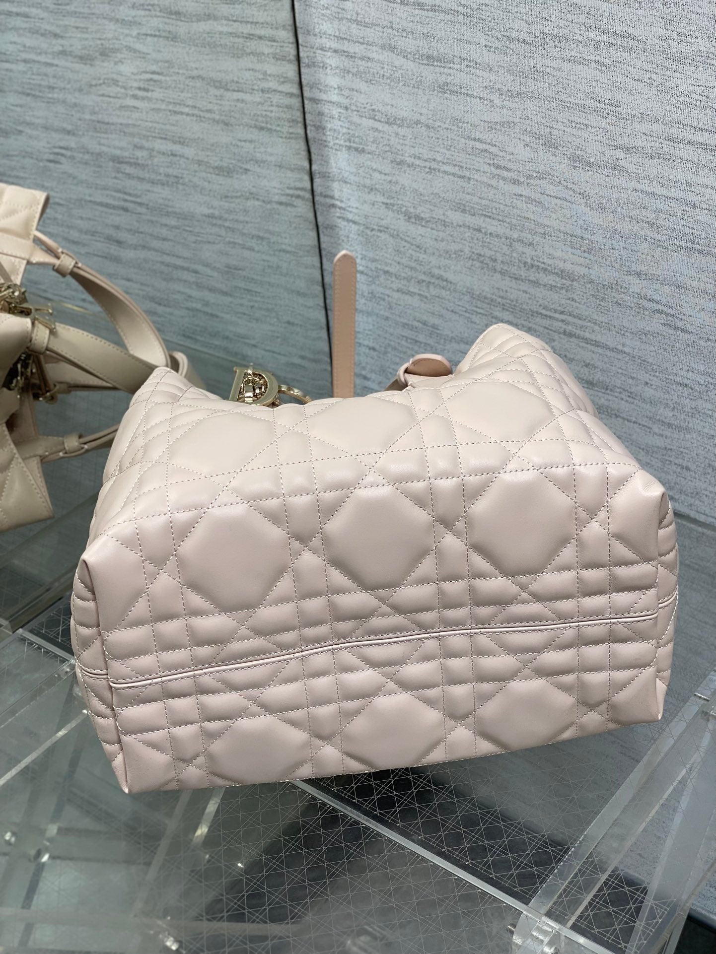 Light pink quilted handbag with front pocket and top handles