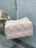 Dior quilted handbag in light pink with front flap and gold-tone feet