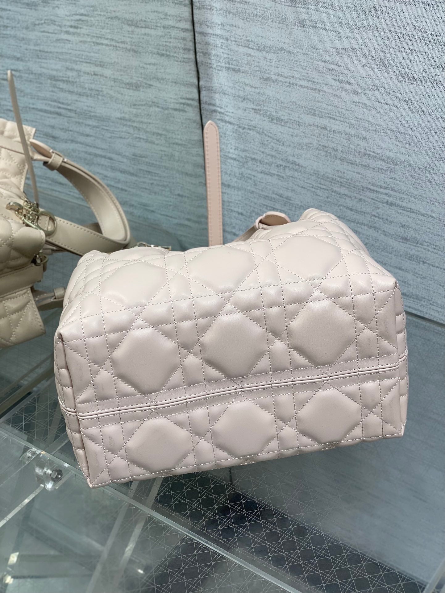 Dior quilted handbag in light pink with front flap and gold-tone feet