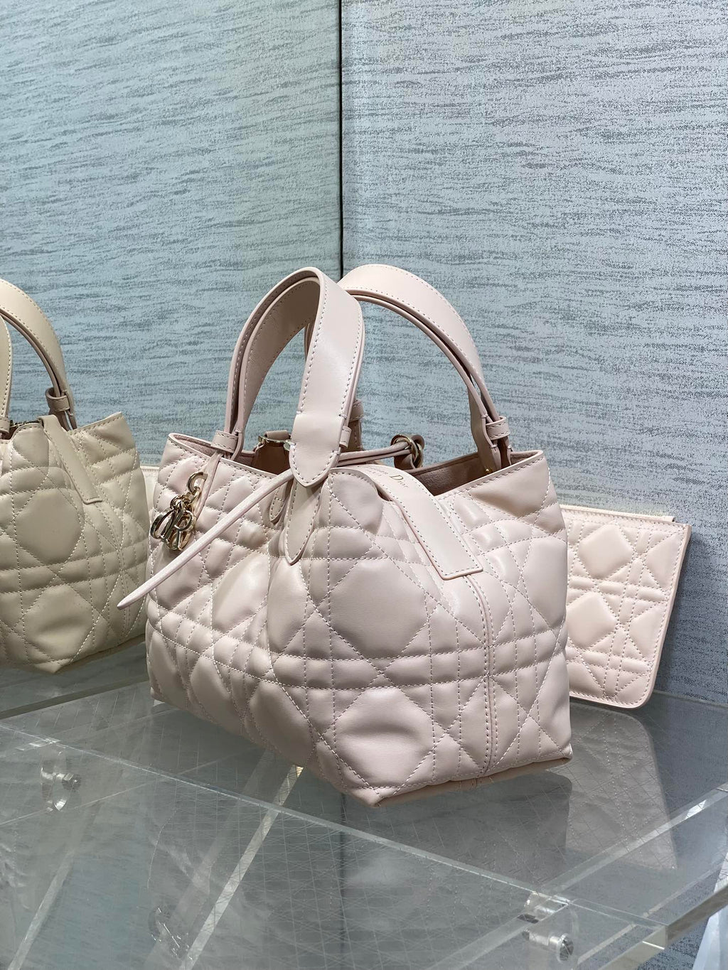 Dior quilted handbag in light pink with top handles and adjustable strap