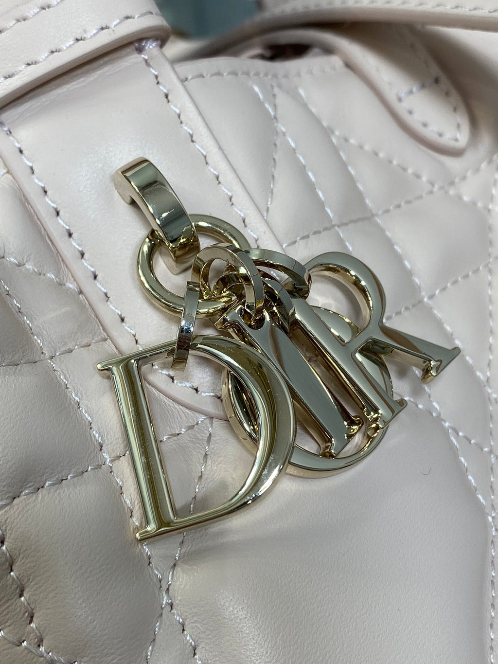 Dior quilted handbag hardware close-up with gold-tone clasp and rings