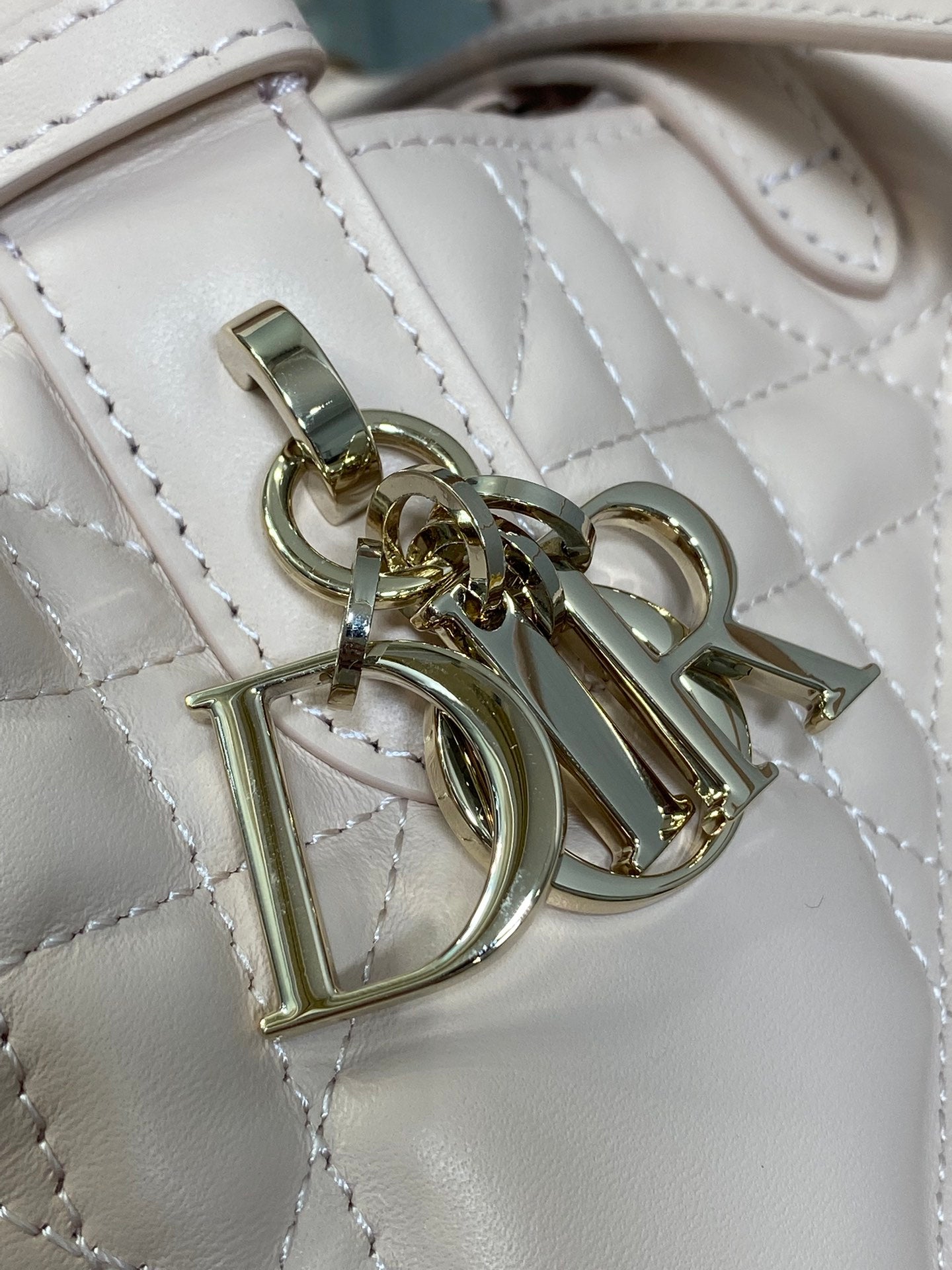 Dior quilted handbag hardware close-up with gold-tone clasp and rings