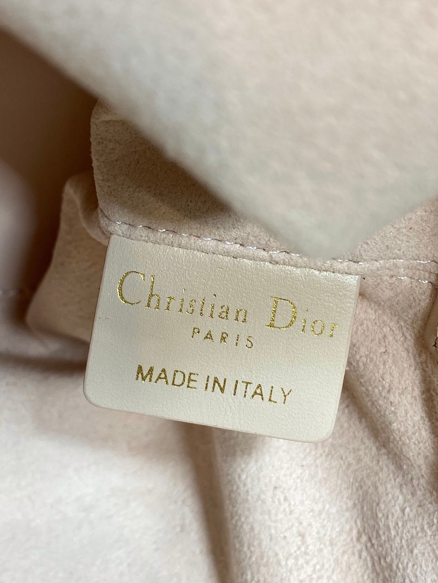 Dior leather tag reading Christian Dior Paris and Made in Italy