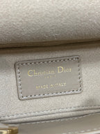 Christian Dior Paris Made in Italy label on beige handbag
