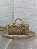 Beige quilted handbag with top handles, gold-tone hardware, and adjustable shoulder strap