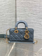 Dior quilted handbag with top handles, gold rings, and adjustable blue crossbody strap
