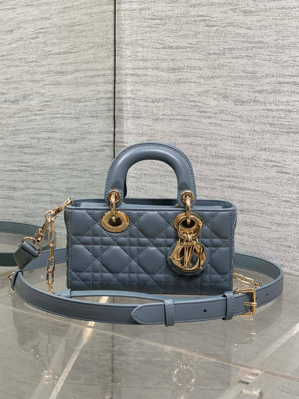Dior quilted handbag in powder blue with top handles and gold chain strap hardware
