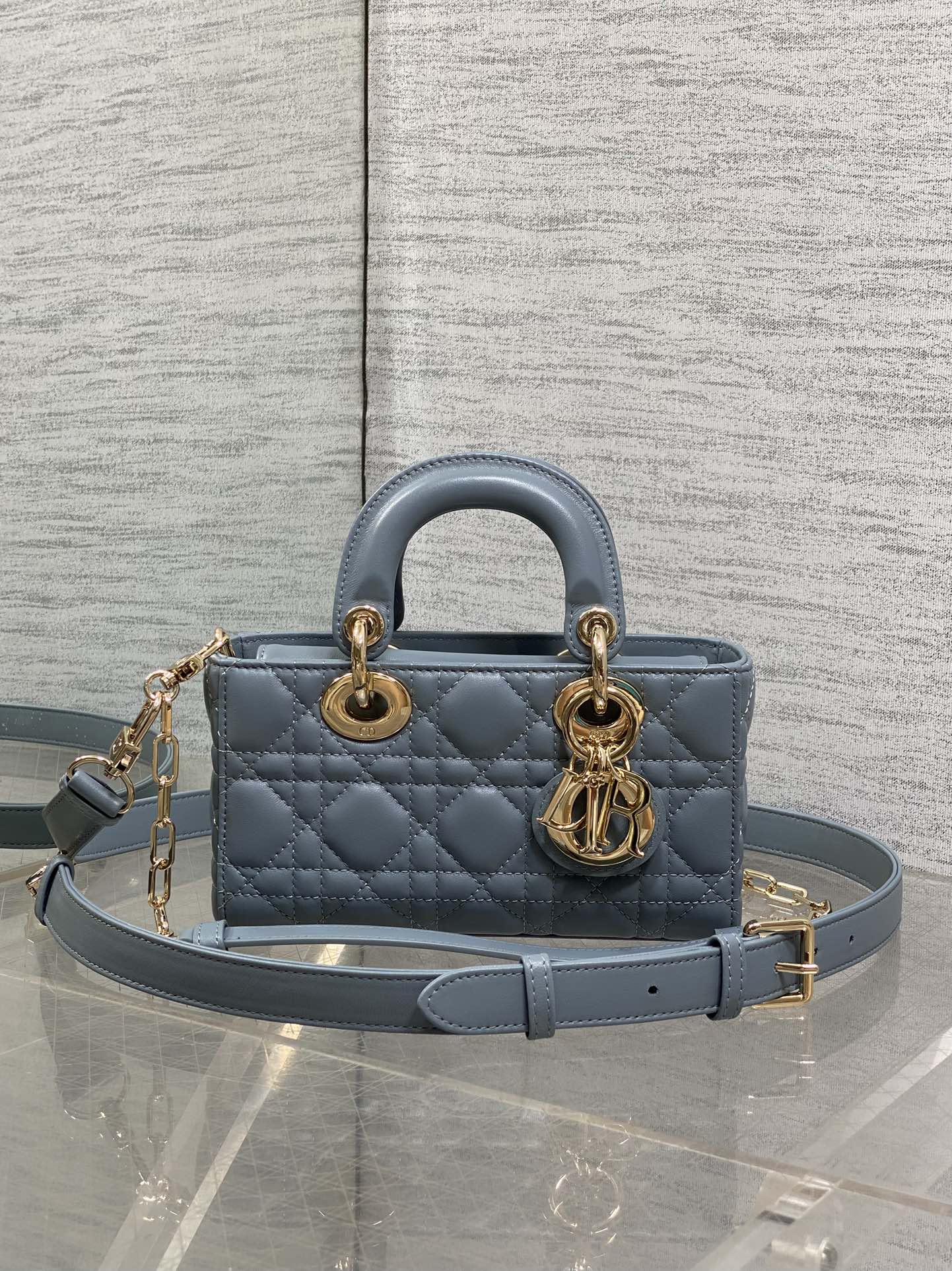 Dior quilted handbag in powder blue with top handles and gold chain strap hardware