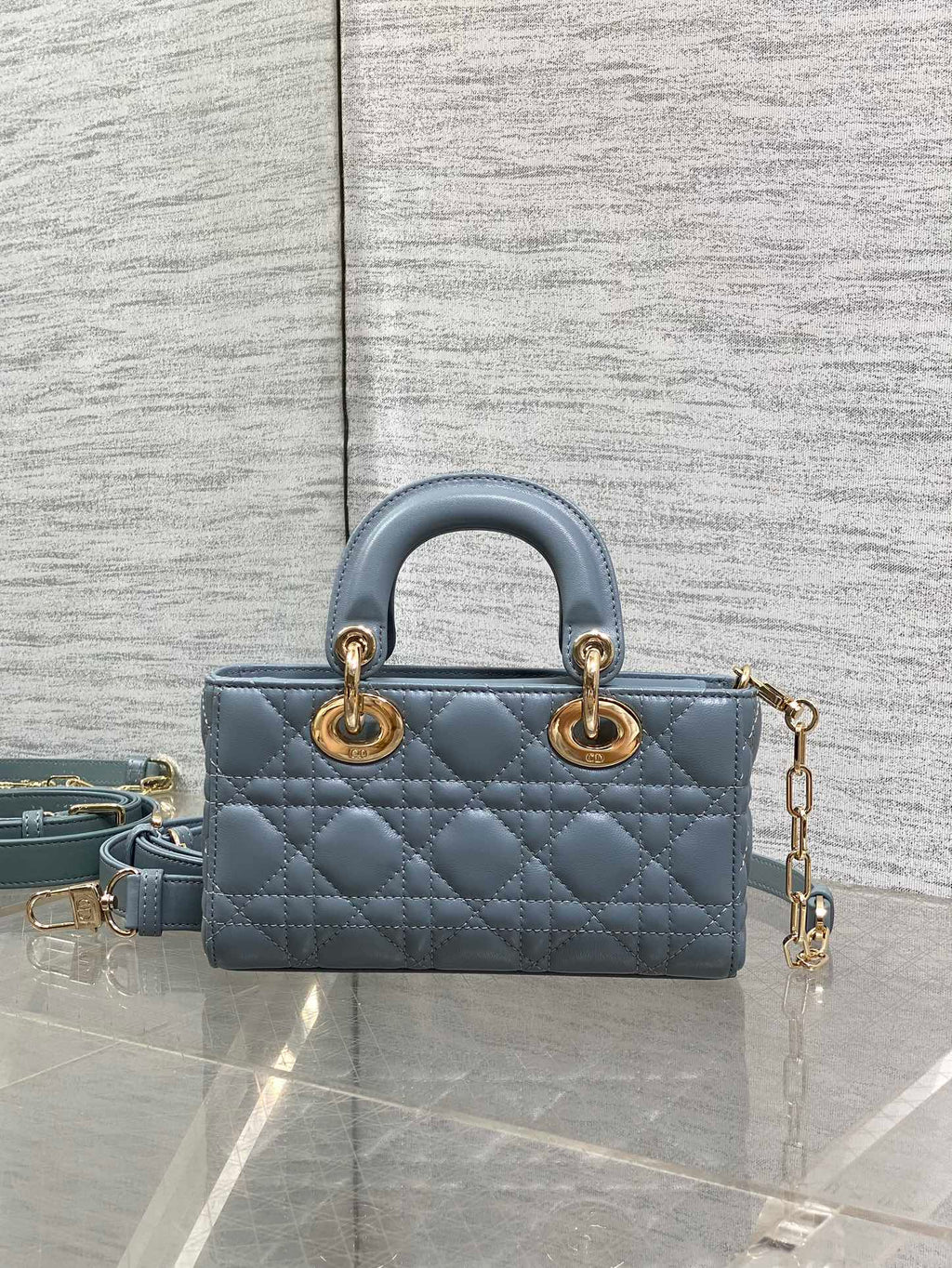 Dior quilted mini handbag in powder blue with top handles and gold chain strap
