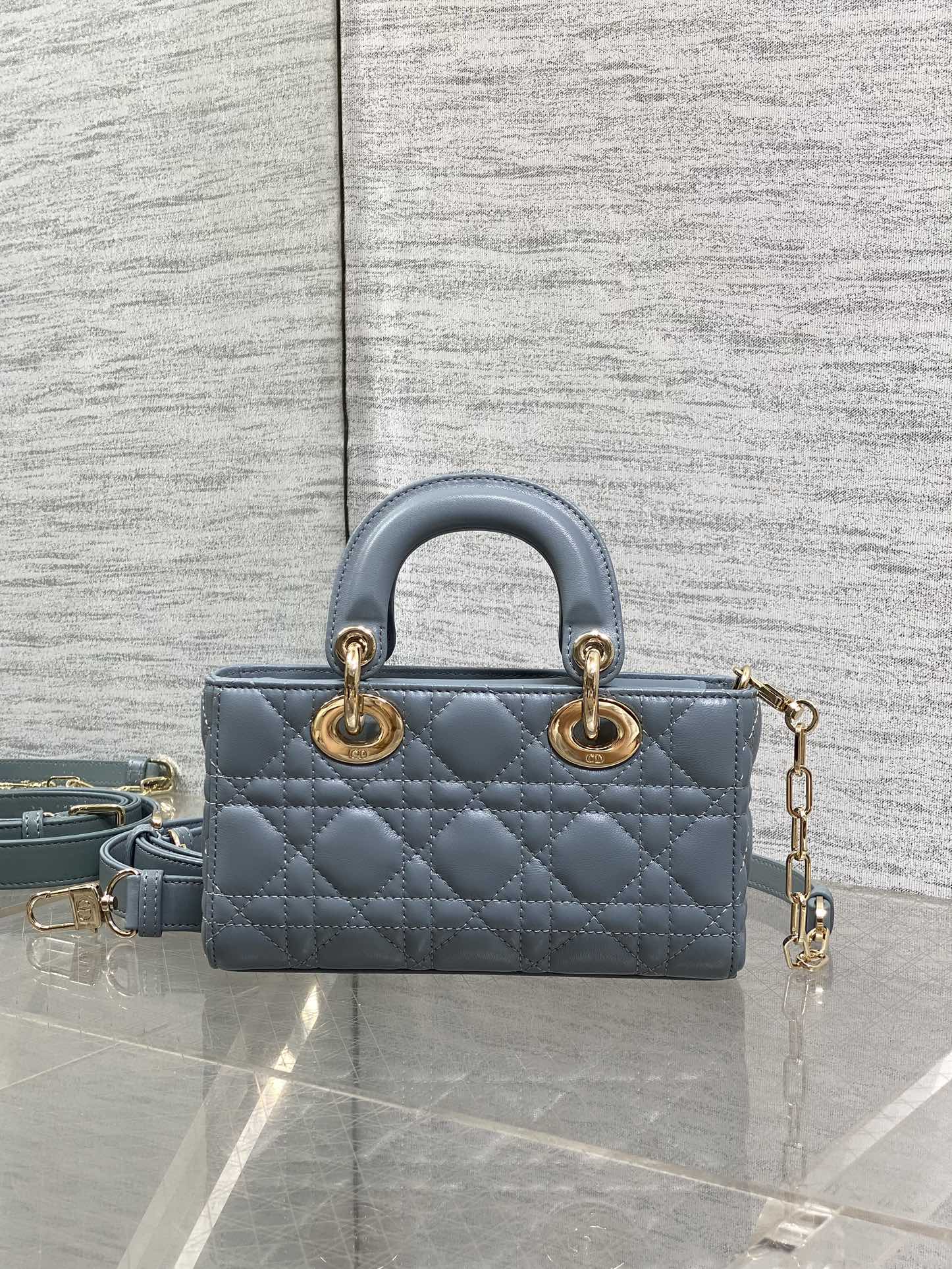Dior quilted mini handbag in powder blue with top handles and gold chain strap