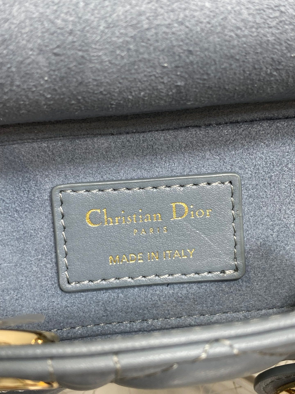 Dior handbag leather logo tag reading "Christian Dior" and "Made in Italy"