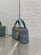 Dior quilted handbag side view in powder blue with gold hardware and chain strap
