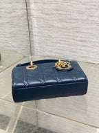 Dior mini handbag top view in navy quilted leather with gold-tone logo clasp