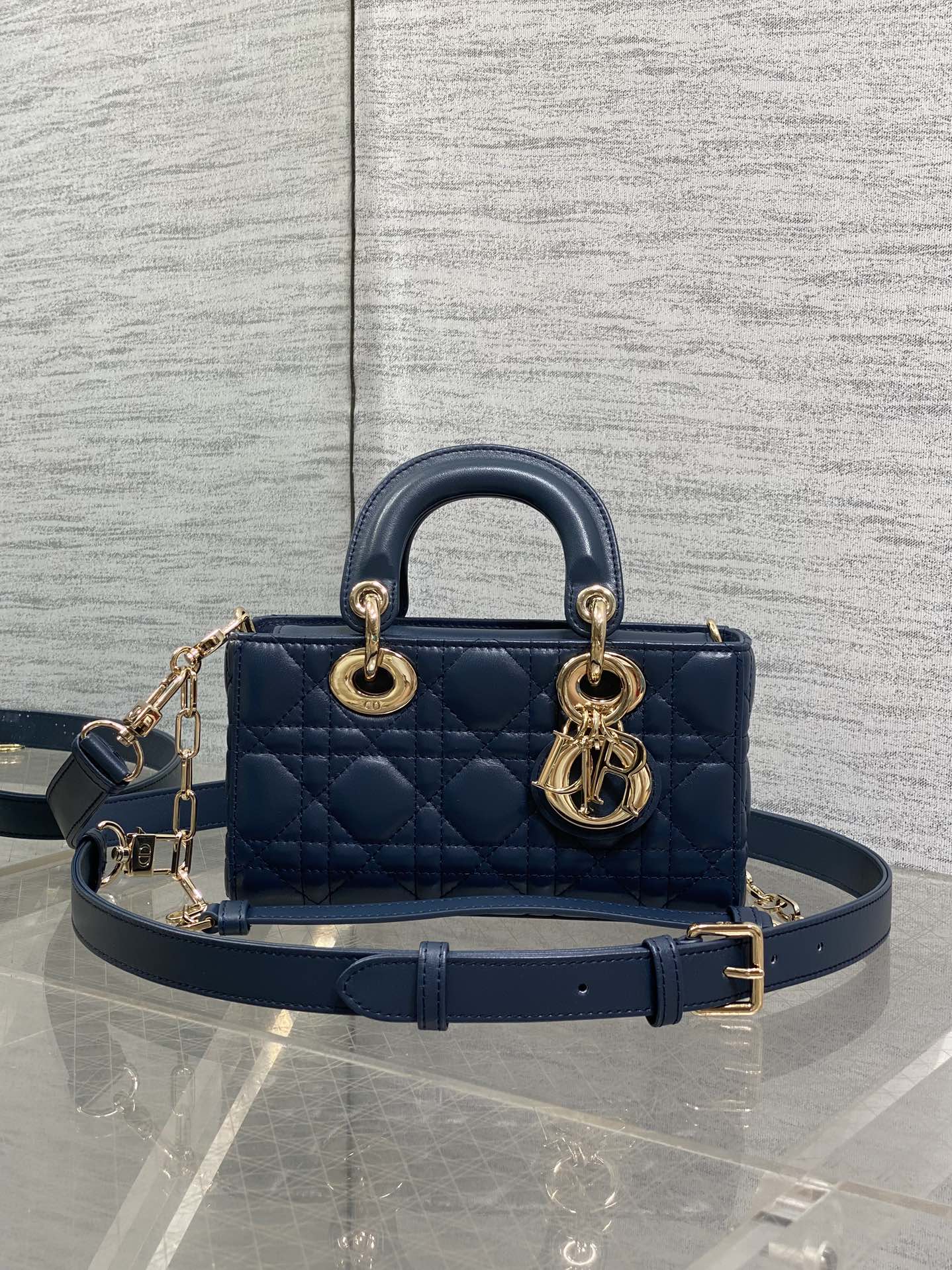 Dior mini handbag in navy quilted leather, gold-tone top handles and chain strap