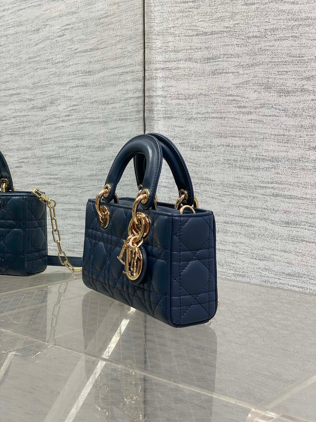 Dior mini handbag in navy quilted leather with gold-tone chain strap and top handles