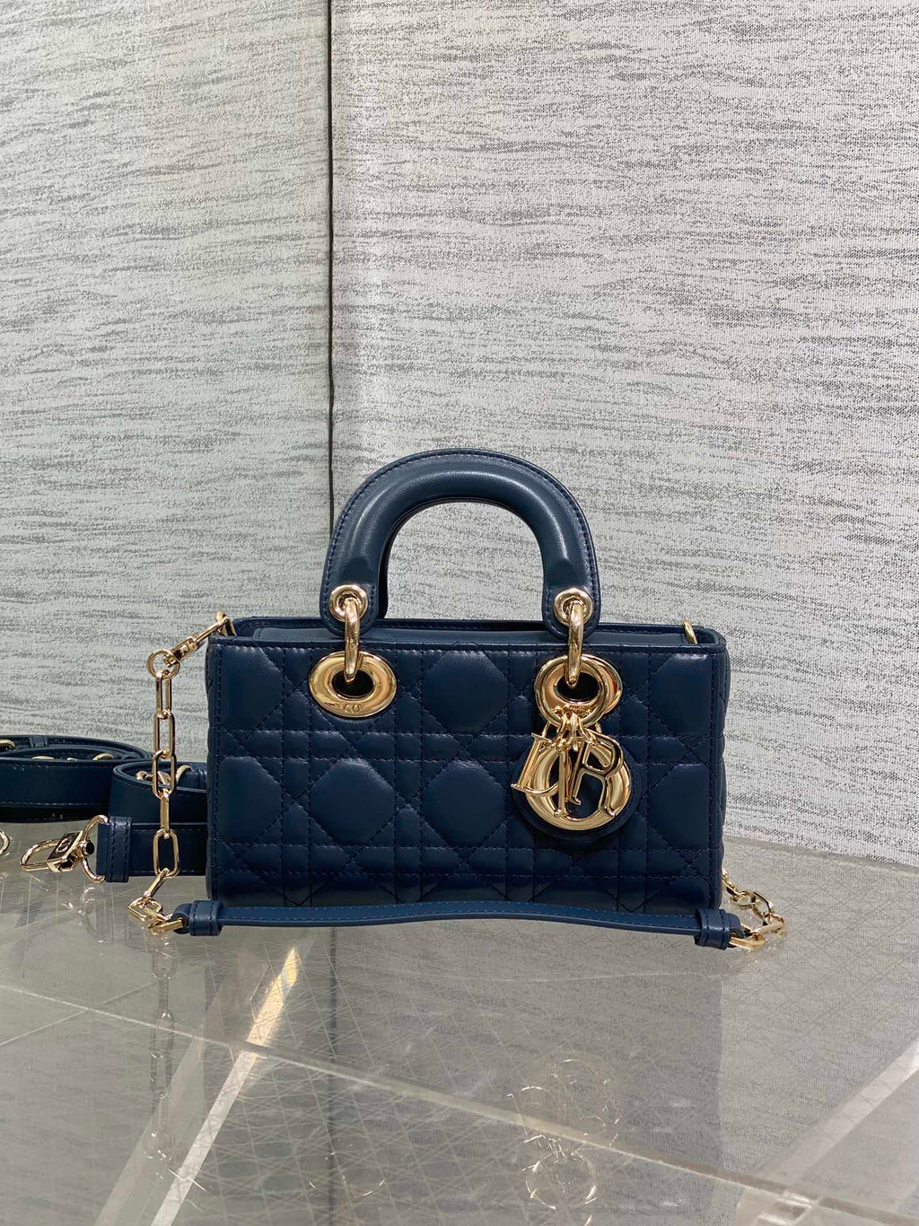 Dior mini handbag in navy quilted leather with gold-tone hardware and shoulder strap