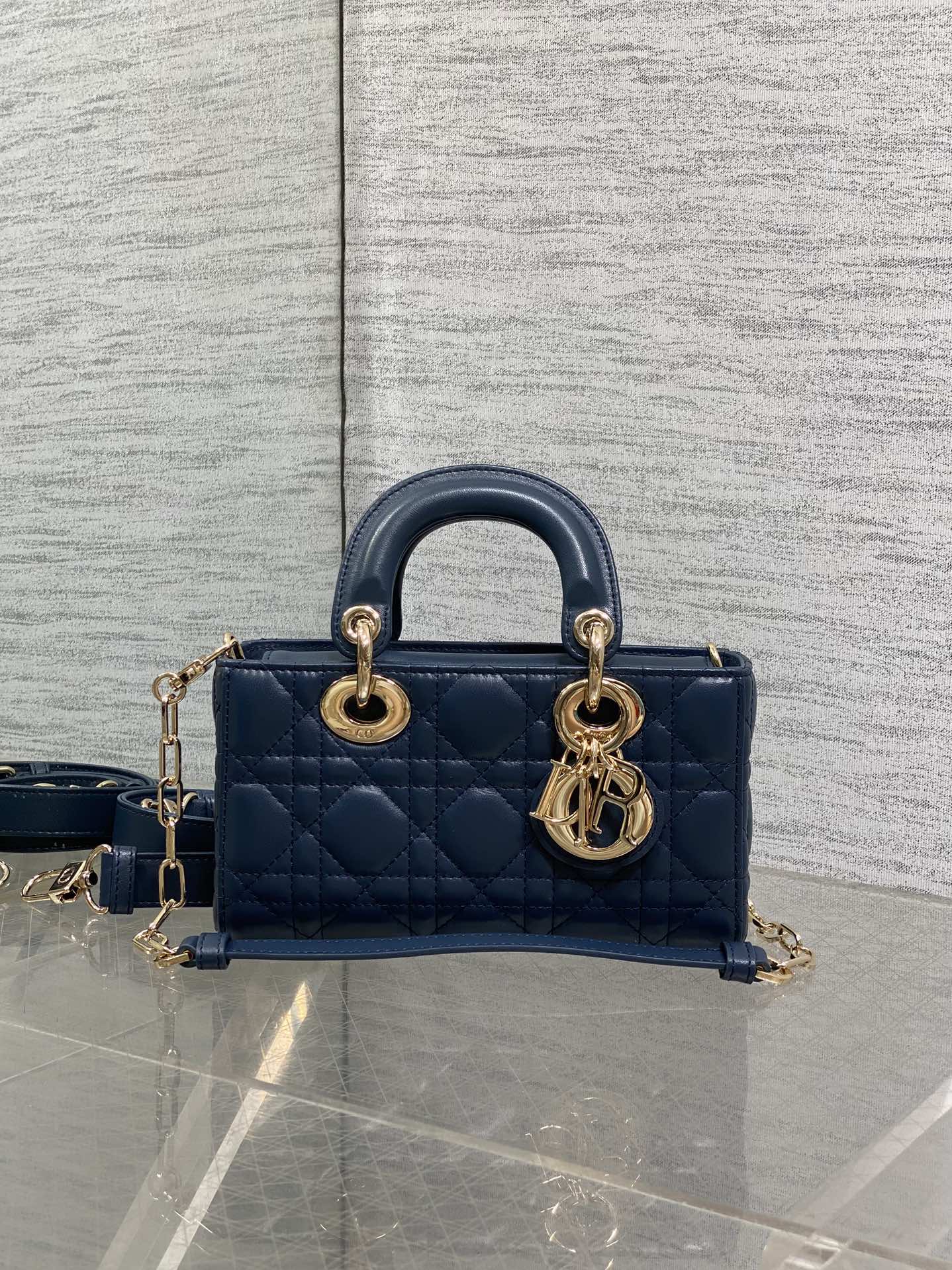 Dior mini handbag in navy quilted leather with gold-tone hardware and shoulder strap