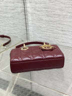 Dior quilted mini handbag with burgundy leather top, gold emblem on front