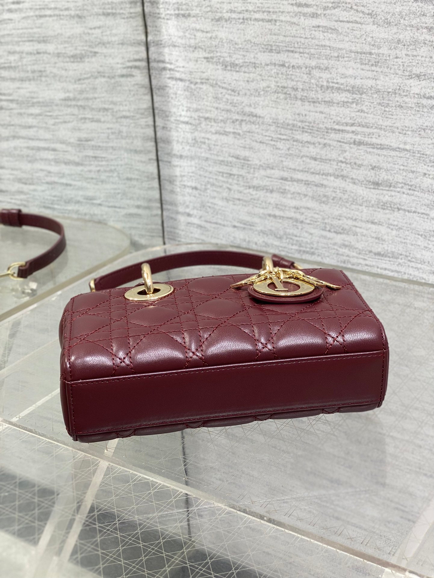 Dior quilted mini handbag with burgundy leather top, gold emblem on front