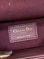 Dior leather label on burgundy bag reading “Christian Dior” and “Made in Italy”