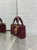 Dior quilted mini handbag in burgundy leather with gold-tone chain and side profile