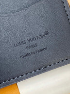 Close-up of Louis Vuitton card holder imprint, 'made in France' on dark blue leather