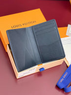 Small Louis Vuitton leather card holder, open view showing multiple card slots