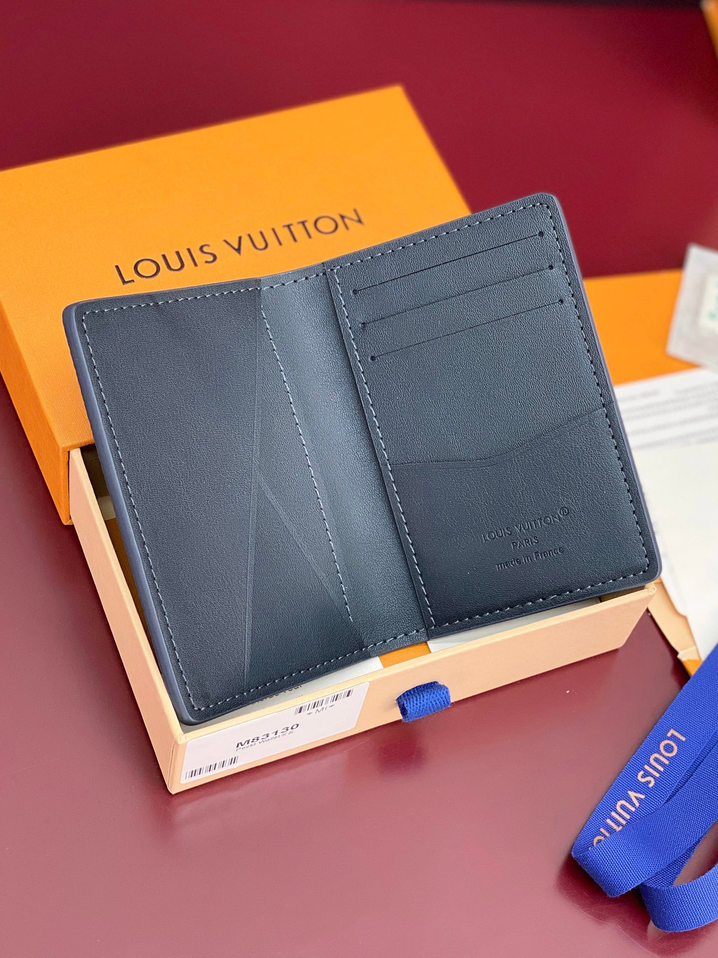 Small Louis Vuitton leather card holder, open view showing multiple card slots