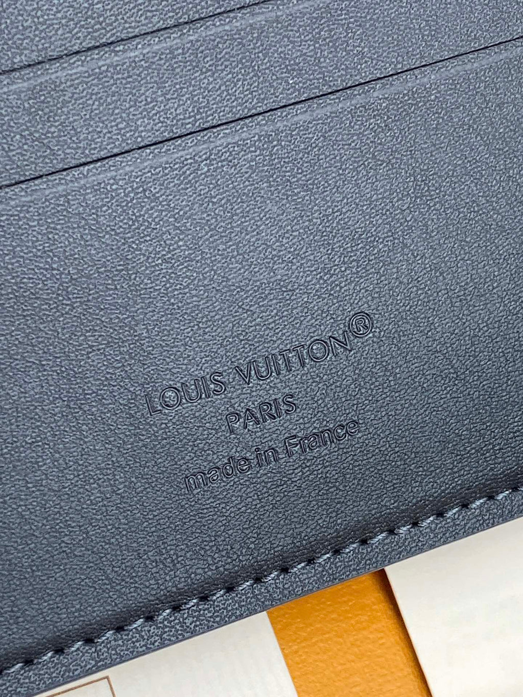 Louis Vuitton small bag, dark blue textured leather with embossed logo and stitching