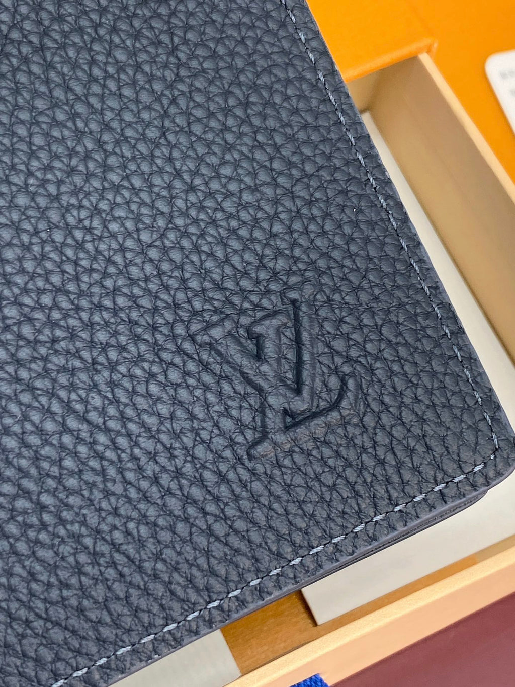 Louis Vuitton small bag, dark blue textured leather corner with embossed LV monogram