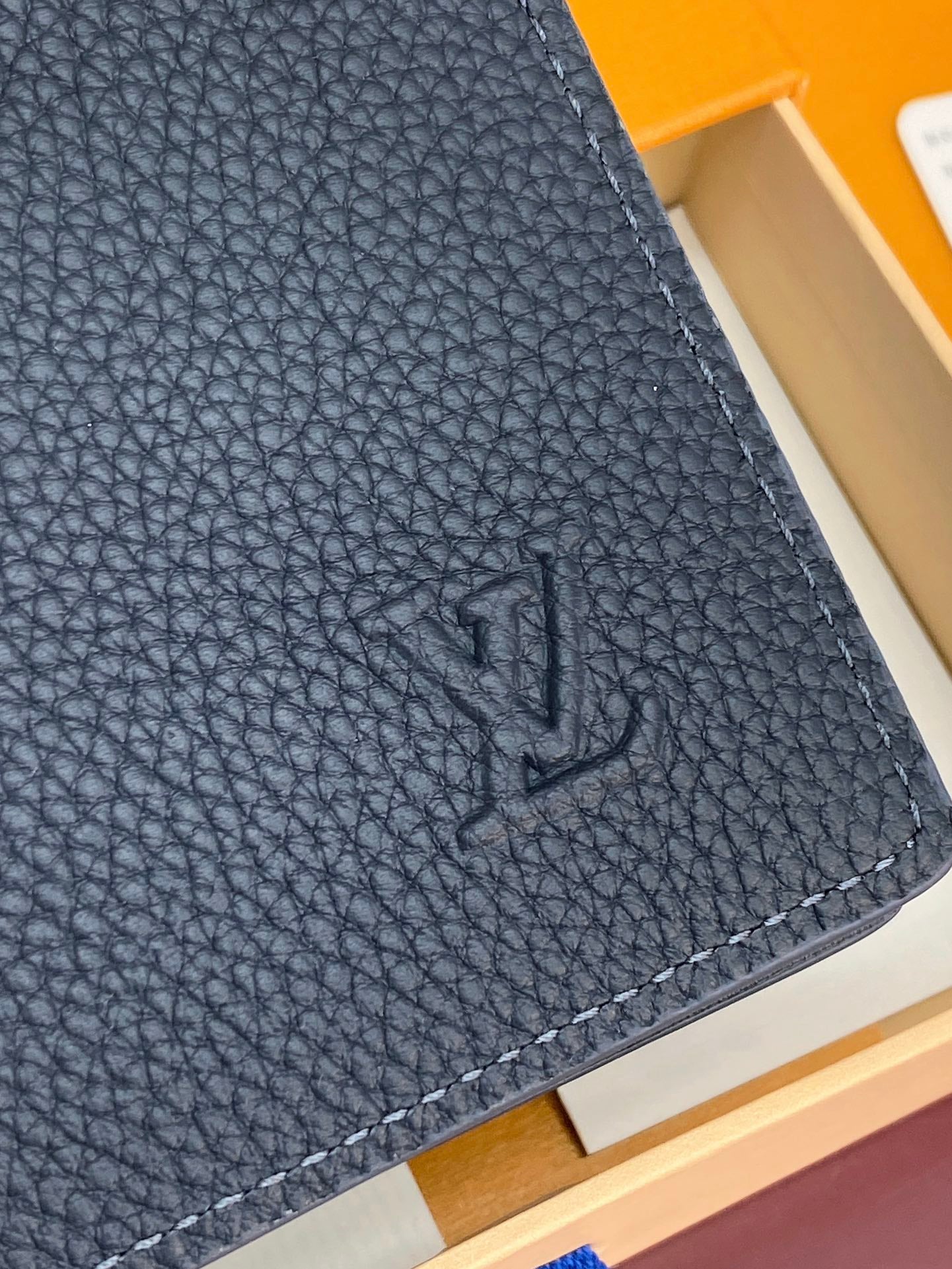 Louis Vuitton small bag, dark blue textured leather corner with embossed LV monogram