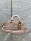 Pink quilted Dior bag with top handles, gold hardware and chain shoulder strap