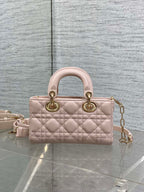 Pink quilted Dior handbag with top handles and gold chain shoulder strap, front view