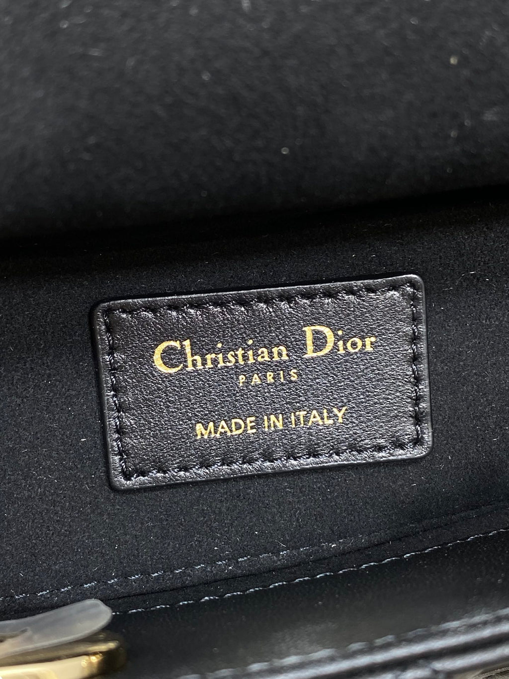Dior handbag interior label with text Christian Dior, PARIS, and MADE IN ITALY