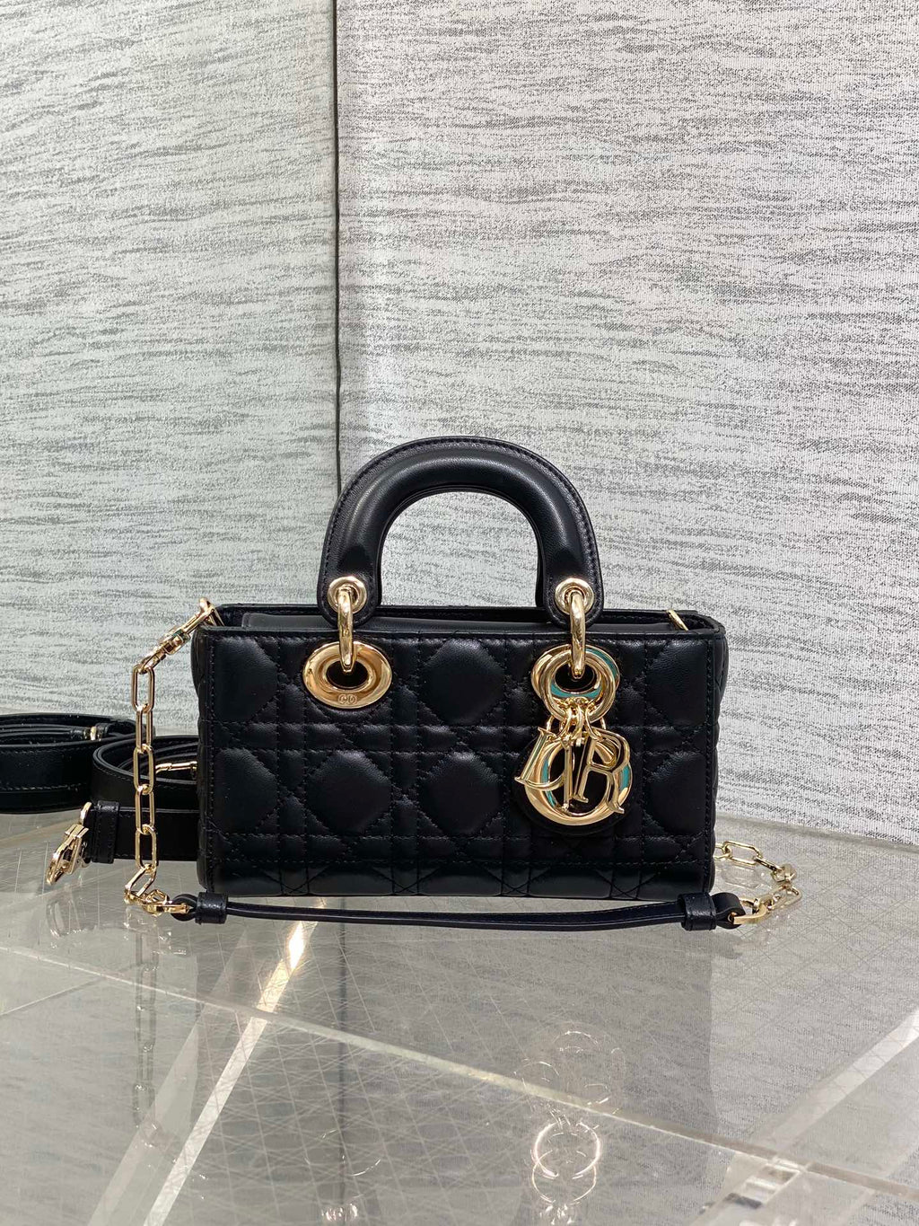 Dior quilted mini handbag with rounded top handles, gold-tone hardware, and shoulder strap