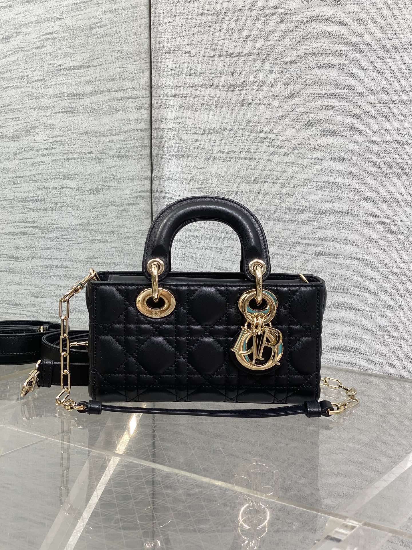 Dior quilted mini handbag with rounded top handles, gold-tone hardware, and shoulder strap