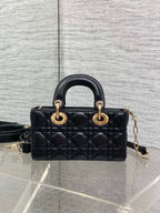 Dior quilted mini handbag front view with top handles, gold rings, and crossbody strap