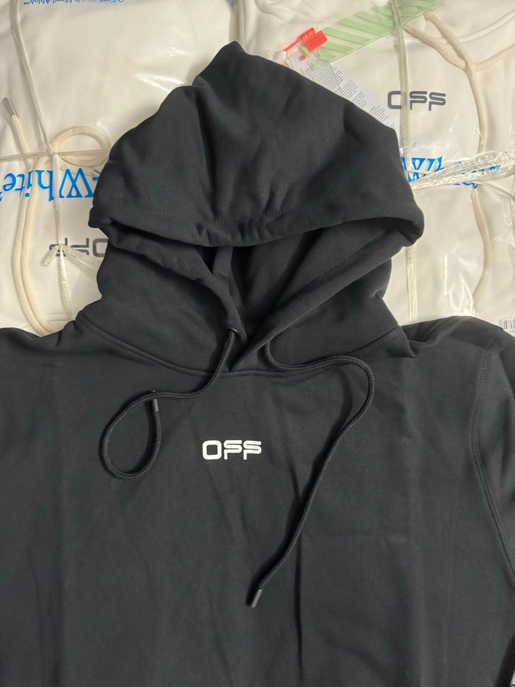 Black hoodie with front pocket, drawstrings, and OFFS logo on the chest